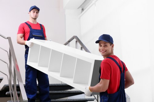Experienced movers preparing furniture for transport in Putney